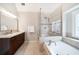 Bright main bathroom with a soaking tub and glass shower at 4910 Hunters Oaks Ln, Alpharetta, GA 30009