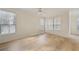 Sunlit bedroom showcasing gleaming wood floors, large windows, and neutral walls at 3777 Peachtree Ne Rd # 1007, Atlanta, GA 30319