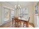 Inviting dining area features warm wood floors, a modern chandelier, and a glass patio door at 3777 Peachtree Ne Rd # 1007, Atlanta, GA 30319