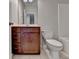 Bathroom features a vanity with wooden drawers, a toilet, and a bathtub, perfect for relaxation and functionality at 4498 Dunblane Ave, Sugar Hill, GA 30518