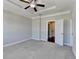Bedroom with neutral walls, carpet, and doorway to stairs at 4498 Dunblane Ave, Sugar Hill, GA 30518