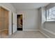 Bedroom features neutral carpet and paint, window with blinds, and closet with shelving at 4498 Dunblane Ave, Sugar Hill, GA 30518