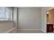 Bedroom features neutral carpet and paint, with natural light entering from a window with white blinds at 4498 Dunblane Ave, Sugar Hill, GA 30518