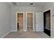 Bedroom with gray walls has two closet doors with access to bathroom featuring white bathtub at 4498 Dunblane Ave, Sugar Hill, GA 30518