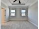 Bright bedroom with neutral walls, carpet, two windows and a ceiling fan at 4498 Dunblane Ave, Sugar Hill, GA 30518