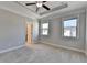 Bright bedroom with neutral walls, carpet, two windows and a ceiling fan at 4498 Dunblane Ave, Sugar Hill, GA 30518