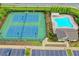 Aerial view showcases a community pool, clubhouse, and tennis courts surrounded by lush landscaping at 4498 Dunblane Ave, Sugar Hill, GA 30518