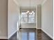 Dining room featuring hardwood floors, neutral walls, a chandelier and lots of natural light at 4498 Dunblane Ave, Sugar Hill, GA 30518