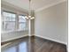 Dining room featuring hardwood floors, neutral walls, a chandelier and lots of natural light at 4498 Dunblane Ave, Sugar Hill, GA 30518