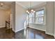 Dining room featuring hardwood floors, neutral walls, a chandelier and lots of natural light at 4498 Dunblane Ave, Sugar Hill, GA 30518