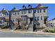 Inviting townhome with brick facade, landscaped yard, and steps to covered entry at 4498 Dunblane Ave, Sugar Hill, GA 30518
