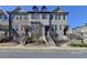 Attractive townhome featuring a brick facade, landscaped front yard, and welcoming entrance at 4498 Dunblane Ave, Sugar Hill, GA 30518