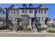 Charming townhome featuring a brick facade, landscaped front yard, and inviting entrance steps at 4498 Dunblane Ave, Sugar Hill, GA 30518