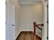 Hallway with hardwood floors, white walls, and modern decor at 4498 Dunblane Ave, Sugar Hill, GA 30518