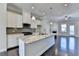 Modern kitchen featuring granite countertops, stainless steel appliances, and open living space at 4498 Dunblane Ave, Sugar Hill, GA 30518