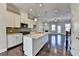 Spacious kitchen featuring granite countertops, stainless steel appliances, and open layout to living space at 4498 Dunblane Ave, Sugar Hill, GA 30518