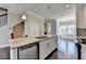 Kitchen with stainless steel appliances, granite countertops, and an island with a sink, faucet, and dishwasher at 4498 Dunblane Ave, Sugar Hill, GA 30518