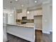 Open concept kitchen with stainless steel appliances, granite countertops, and a kitchen island with a sink at 4498 Dunblane Ave, Sugar Hill, GA 30518