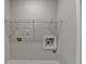 A simple and functional laundry room featuring practical shelving and utility connections, designed for efficiency at 4498 Dunblane Ave, Sugar Hill, GA 30518