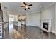Living room with hardwood floors, a fireplace and an open concept kitchen with a kitchen island at 4498 Dunblane Ave, Sugar Hill, GA 30518