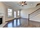 Bright living room with hardwood floors, fireplace, ceiling fan and access to the outside deck through a glass door at 4498 Dunblane Ave, Sugar Hill, GA 30518