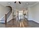 Open concept living room leading to the kitchen with white cabinets and stainless steel appliances at 4498 Dunblane Ave, Sugar Hill, GA 30518