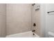 A tiled shower and tub combination showcasing modern fixtures and tile and offering both convenience and style at 628 Avondale Hills Dr, Decatur, GA 30032