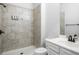Modern bathroom with tiled shower, rainfall shower head and a sleek white vanity at 628 Avondale Hills Dr, Decatur, GA 30032