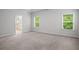 Spacious primary bedroom with neutral carpet, natural light, and ensuite bathroom access at 628 Avondale Hills Dr, Decatur, GA 30032