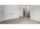 Carpeted bedroom featuring double doors leading to a closet or storage space at 628 Avondale Hills Dr, Decatur, GA 30032