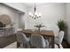 Elegant dining room with a modern chandelier, wainscoting, and a wooden table set for six at 628 Avondale Hills Dr, Decatur, GA 30032