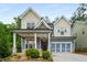 Charming craftsman-style home featuring a welcoming front porch, blue siding, and well-manicured landscaping at 628 Avondale Hills Dr, Decatur, GA 30032
