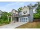 Two-story home with a covered front porch, attached garage, blue siding, and professional landscaping at 628 Avondale Hills Dr, Decatur, GA 30032