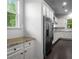 Bright kitchen boasts white cabinets, granite countertops, and stainless steel appliances at 628 Avondale Hills Dr, Decatur, GA 30032