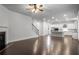 Bright, open-concept living room featuring hardwood floors, fireplace, and seamlessly flowing into a modern white kitchen at 628 Avondale Hills Dr, Decatur, GA 30032