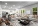 Open living room and kitchen area, featuring hardwood floors, stainless steel appliances, and comfortable seating at 628 Avondale Hills Dr, Decatur, GA 30032