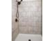 Walk-in shower featuring tile and dark plumbing fixtures at 628 Avondale Hills Dr, Decatur, GA 30032