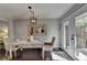 Cozy dining area featuring a rustic wooden table and chairs with natural light from patio doors at 136 Peachtree Memorial Nw Dr # Ct3, Atlanta, GA 30309