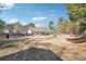 Expansive backyard with fire pit and established trees at 1369 Sierra Ridge Pl, Loganville, GA 30052