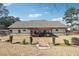 Spacious backyard featuring a covered patio and fire pit area at 1369 Sierra Ridge Pl, Loganville, GA 30052