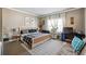 Cozy bedroom with neutral tones, a patterned rug, a comfortable bed and ample natural light from the large windows at 1369 Sierra Ridge Pl, Loganville, GA 30052
