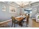 Inviting dining room with decorative chandelier and open view to the kitchen at 1369 Sierra Ridge Pl, Loganville, GA 30052