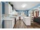 Modern kitchen featuring stainless steel appliances, island, and seamless flow into the living area at 1369 Sierra Ridge Pl, Loganville, GA 30052