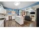 Bright kitchen with an island, stainless steel appliances, and an open layout view of the living room at 1369 Sierra Ridge Pl, Loganville, GA 30052