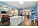 Contemporary kitchen with a central island, leading to a spacious living and dining area at 1369 Sierra Ridge Pl, Loganville, GA 30052