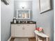 Charming powder room with modern cabinets and fixtures at 1369 Sierra Ridge Pl, Loganville, GA 30052