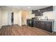 Basement kitchenette with black appliances, wood cabinets, and hardwood floors at 2520 Cross Springs Dr, Cumming, GA 30041