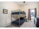This bedroom features a gray bunk bed, a window with neutral curtains, and tan walls at 2520 Cross Springs Dr, Cumming, GA 30041