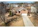 Aerial view of a brick two-story home with lush landscaping, mature trees, and a long driveway at 2520 Cross Springs Dr, Cumming, GA 30041