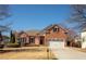 Charming two-story brick home with a well-manicured lawn and an attached two-car garage at 2520 Cross Springs Dr, Cumming, GA 30041